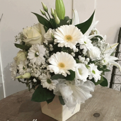 In the Garden Arrangement - A timeless classic arrangement in white scented flowers beautifully arranged in a cream ceramic container.