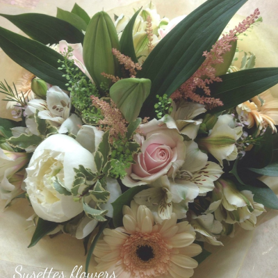 Happiness Bouquet - A beautiful classic selection of seasonal flowers in peaches and cream with a touch of the countryside, , including scented dutch oriental lilys, roses, alstromeria, thlaspia and gerbras. A sure way to brighten someones special day.

A bright scented and cheerful bouquet handtied and delivered in water by your local florist Susettes Flowers in bury St Edmunds.

Please note that due to the seasonal availability of flowers it may be necessary to vary individual stems from those shown. Our skilled florists may substitute flowers for one similar in style, quality and value. Where our designs include a sundry item like a vase or basket it may not always be possible to include the exact item as displayed. If such an occasion arises we will make every effort to replace the item with a suitable alternative.