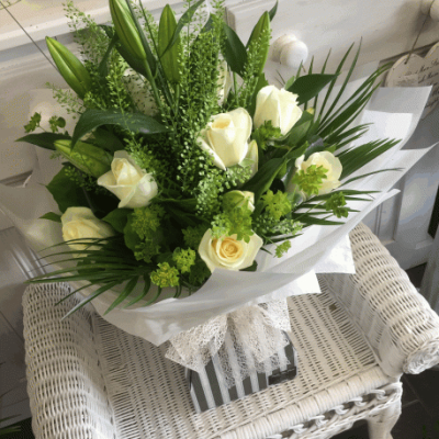 White Lily & Rose Handtied - A beautiful and stunninly scented handtied bouquet, using the best dutch scented Lily and beautiful White Roses, together with thlaspi, palm and seasonal foliages, a real show stopper and a sure way to brighten someones special day.

A beautifully scented and classic bouquet handtied and delivered in water by your local florist Susettes Flowers in Bury St Edmunds.

Image shown deluxe

Please note that due to the seasonal availability of flowers it may be necessary to vary individual stems from those shown. Our skilled florists may substitute flowers for one similar in style, quality and value. Where our designs include a sundry item like a vase or basket it may not always be possible to include the exact item as displayed. If such an occasion arises we will make every effort to replace the item with a suitable alternative.