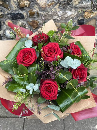 Six Stolen Kisses - Six stolen kisses, six of the best red freedom roses mixed with seasonal foliages and gypsophila prestened in a stylishvase. A perfect gift for your loved one this valentines day or simply to send your love. All floral displays are hand delivered by our friendly team at Susettes flowers. Balloons, chocolates and teddy bears also available as add on tems. Same day delivery is available in Bury St Edmunds and surrounding villages on orders placed before 1pm. 

We also offer a wide range of other beautifully coloured roses, please do not hesitate to contact us. Our fully qualified florists would be more than happy to advise you.