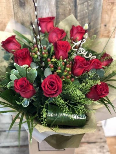 Luxury Red Dozen - Simply the best dozen red roses mixed with seasonal foliage, pussy willow, red hypericum berries finished with folded aspadistra and palm leaves, delivered handtied in water.

When only the best will do...This is the perfect romantic flower delivery on Valentine's Day or any other day just because......

Image shown is 12 red roses (standard).

Also avaiable in 18 (deuluxe) & 24 (luxury)

Please note that due to the seasonal availability of flowers it may be necessary to vary individual stems from those shown. Our skilled florists may substitute flowers for one similar in style, quality and value. Where our designs include a sundry item like a vase or basket it may not always be possible to include the exact item as displayed. If such an occasion arises we will make every effort to replace the item with a suitable alternative.