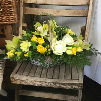 Bereavement Basket - Lemon basket 
A beautiful Cream and yellow basket arrangement. Yellow Roses, Green cymbidium Orchids, Cream Avalanche Roses, Carnations and Lime Hypericum sit perfectly alongside variegated lime Dracaena, Aralia leaves, Eucalyptus, Salal and Willow.

Hand delivered by your local florist in Bury St Edmunds, Susettes Flowers

Image shown is Deluxe.

 

Also available in Standard & Luxury Sizes.

Please note that due to the seasonal availability of flowers it may be necessary to vary individual stems from those shown. Our skilled florists may substitute flowers for one similar in style, quality and value. Where our designs include a sundry item like a vase or basket it may not always be possible to include the exact item as displayed. If such an occasion arises we will make every effort to replace the item with a suitable alternative.