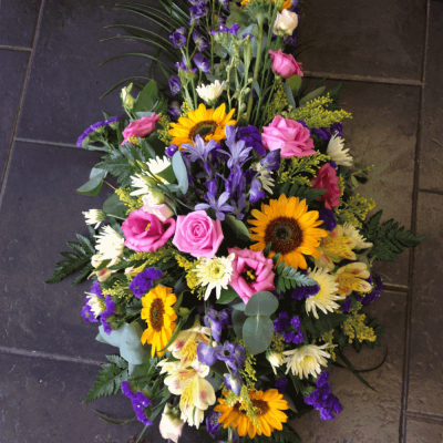 Summer Garden Single Ended Spray - Summer garden Single Ended Spray
A beautiful pink, blue and lemon single ended spary. Roses, Eustomia, Sunflowers, Brodia and Solidiaster sit perfectly alongside blue Delphiniums, Aralia leaves, Cocculus, Salal and Palm,

Hand delivered by your local florist in Bury St Edmunds.

Image shown is Deluxe.

Also available in Standard & Luxury Sizes.

 

Please note that due to the seasonal availability of flowers it may be necessary to vary individual stems from those shown. Our skilled florists may substitute flowers for one similar in style, quality and value. Where our designs include a sundry item like a vase or basket it may not always be possible to include the exact item as displayed. If such an occasion arises we will make every effort to replace the item with a suitable alternative.