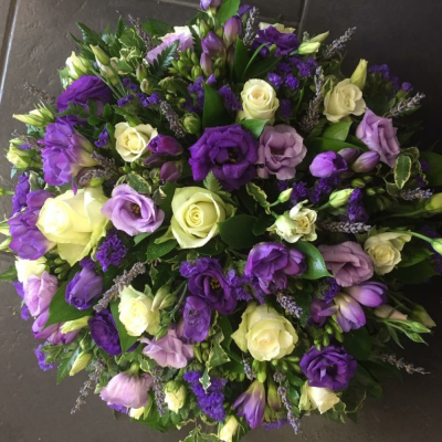 Rose & Freesia Posy Pad - A beautiful cream rose & lilac freesia posy pad. Roses, Chrysanthemums, Eustomia and Freesia sit perfectly alongside touches of lavender, seasonal foliages and China grass.

Hand delivered by your local florist in Bury St Edmunds, Susettes Flowers.

Image shown is Deluxe.

Also available in Standard & Luxury Sizes.