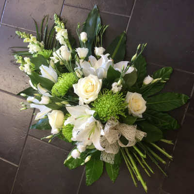 Modern Tied Sheaf - Classic Green & White Mixed Sheaf
A beautiful green and white mixed sheaf. Lilys, Blooms, Roses and Eustomia sit perfectly alongside variegated lime Dracaena, Aralia leaves, Cocculus, Salal and Palm, finished with a rustic hessian bow.

Hand delivered by your local florist in Bury St Edmunds, Susettes Flowers.

Image shown is Large