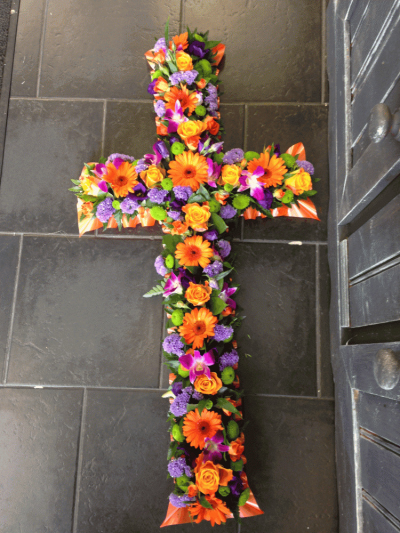 Loose Vibrant Cross - A vibrant floral cross consisting of cerise and orange Roses and Carnations, orange Germini, purple Aconitum and Lisianthus.

Image Shown is standard 3ft

Also available in Medium 4ft and Large 5ft