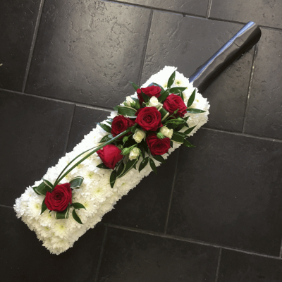 Cricket Bat - A cricket bat and ball shaped tribute. Red Roses and Carnations with white spray Chrysanthemums with a touch of variegated Dracaena, white Hypericum, black Cordyline and Asparagus Fern.