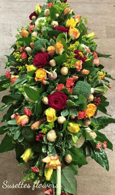 Vegetable Patch Casket Spray - A beautiful Casket Spray with a selection of seasonal vegetables, perfect for a lost loved one with a passion for allotments and gardening, accompanied with red and orange roses and a selection of seasonal blooms

Hand delivered by your local florist in Bury St Edmunds, Susettes Flowers

Image shown is Large 5ft

Also available in Standard 3ft & Medium 4ft Sizes.