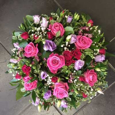 Petite Posy Pad - A beautiful pink rose & lillac eustomia posy pad. Roses, Spray Roses, Eustomiaand Freesias it perfectly alongside Lime Pitto, Gypsophlia and seasonal foliages.

Hand delivered by your local florist in Bury St Edmunds, Susettes Flowers.

Image shown is Medium 14"

Also available in Standard 12" & Large Sizes 16"