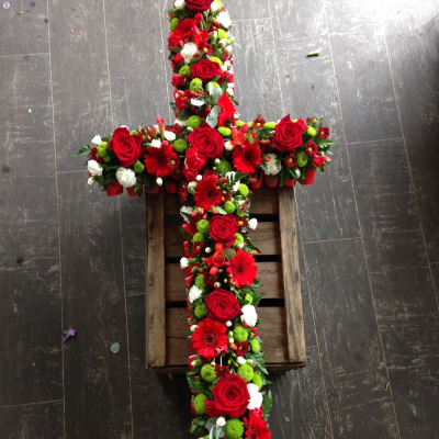 Red Rose Loose Cross - A stunning red white and green Cross with Roses, white Eustomia, green button Crysanthumums, Red Gerbra and red spray Carnations, with a touch of hypericum berrie and seasonal foliage.

Hand delivered by your local florist in Bury St Edmunds, Susettes Flowers.

Image shown is Medium  4ft

Also avaiable in Standard 3ft & Large 5ft Sizes.