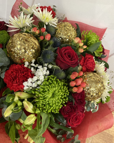 Christmas cracker - A beautiful hand tied bouquet of seasonal foliage and stunning florals in red and gold to create a perfect gift this Christmas.