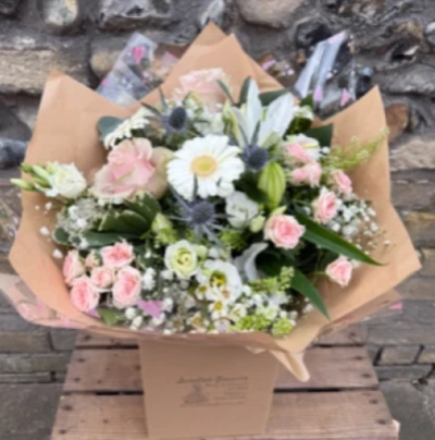 Pastel perfection - A beautifully handcrafted hand tie bouquet created by your local florist using a pastel palette of the freshest blooms, hand delivered to the door. This stunning floral design is a perfect gift, with scented lilies, roses, lisianthus and gerbera framed with a selection of seasonal foliage. 

Available for same day delivery on orders placed before 12 noon